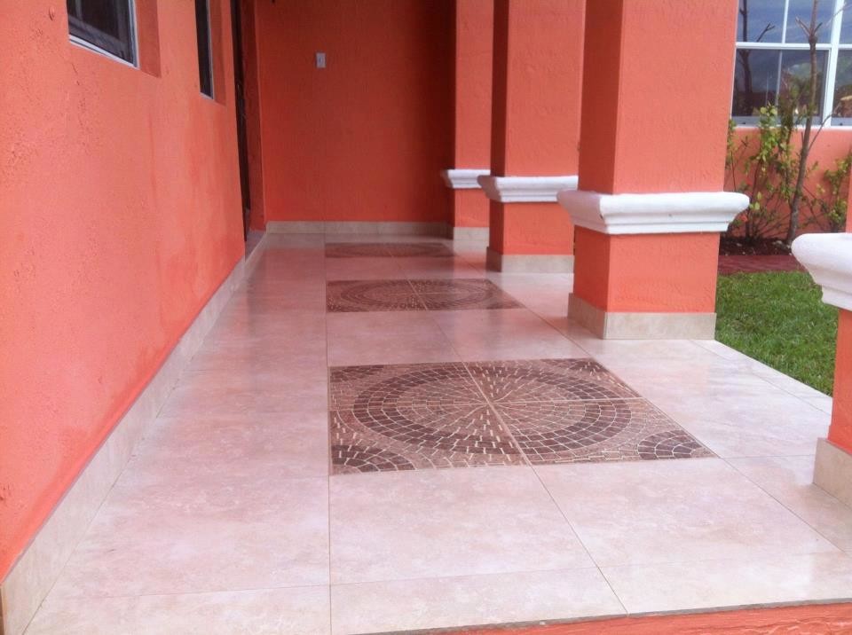 Inspiration for a mid-sized ceramic tile front door remodel in Miami with white walls