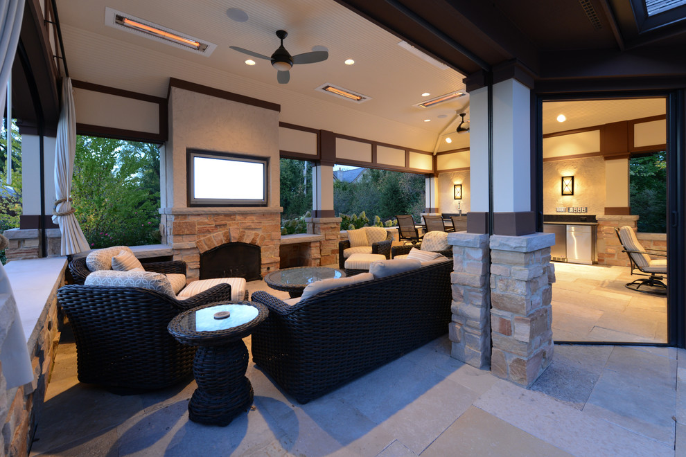 Patio - mid-sized craftsman backyard stone patio idea in Chicago with a roof extension