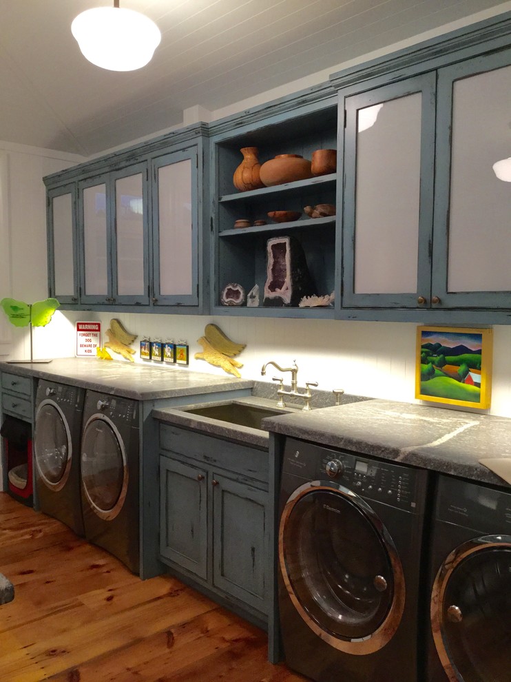 Inspiration for a large country dedicated laundry room in Los Angeles with an undermount sink, recessed-panel cabinets, blue cabinets, marble benchtops, white walls, medium hardwood floors and a side-by-side washer and dryer.