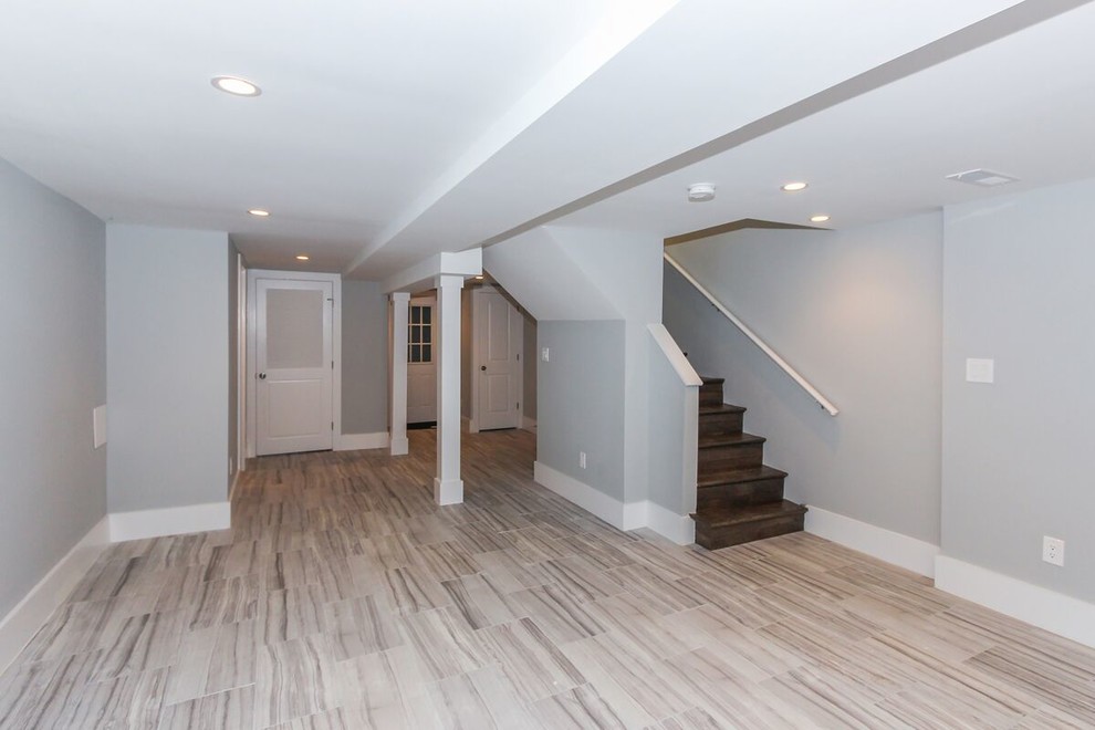 Inspiration for a mid-sized traditional fully buried basement in DC Metro with grey walls, light hardwood floors, no fireplace and beige floor.
