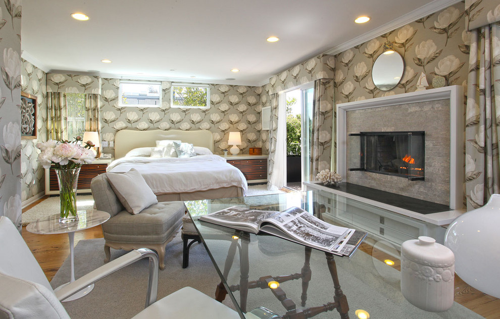 This is an example of a contemporary bedroom in Los Angeles with multi-coloured walls and a ribbon fireplace.