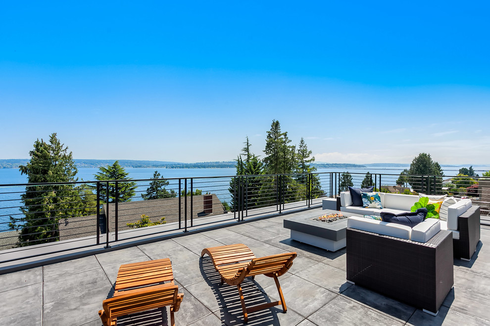 Photo of a contemporary rooftop and rooftop deck in Seattle with a fire feature.