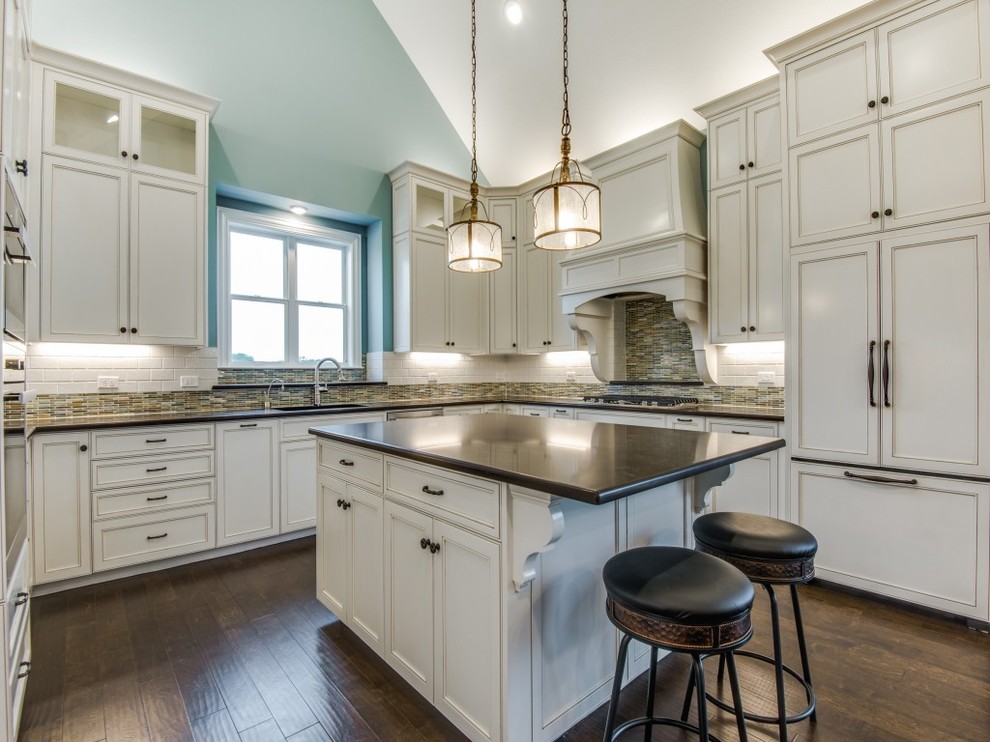 Example of a large transitional u-shaped medium tone wood floor eat-in kitchen design in Dallas with an undermount sink, beaded inset cabinets, white cabinets, quartz countertops, cement tile backsplash, stainless steel appliances and an island