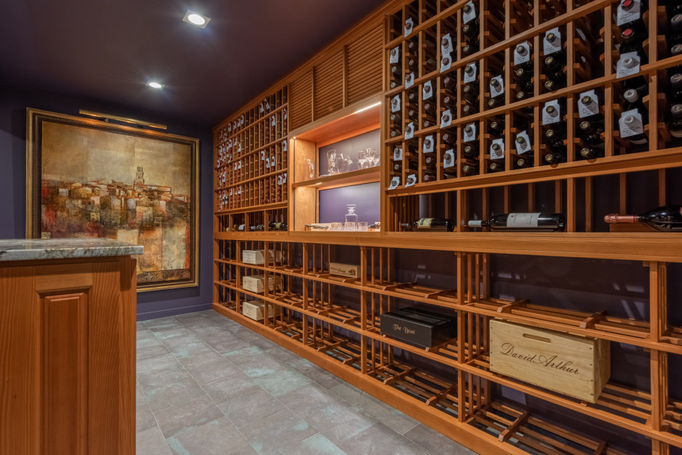 Large country wine cellar in Bridgeport with porcelain floors, storage racks and grey floor.