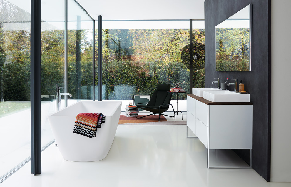 Modern bathroom in Other with flat-panel cabinets, white cabinets, black walls, a vessel sink, wood benchtops, white floor and brown benchtops.