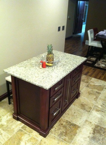 Example of a large galley light wood floor enclosed kitchen design in Cedar Rapids with a drop-in sink, flat-panel cabinets, black cabinets, metallic backsplash and an island