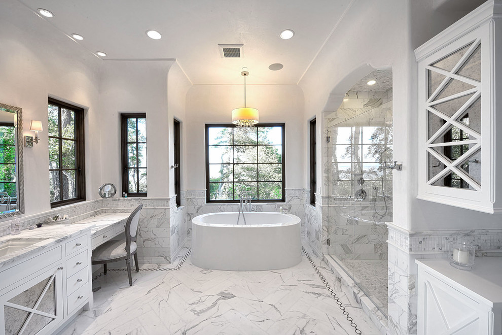 Design ideas for a mediterranean bathroom in San Francisco with an undermount sink, white cabinets, a freestanding tub, an alcove shower, white tile and white walls.