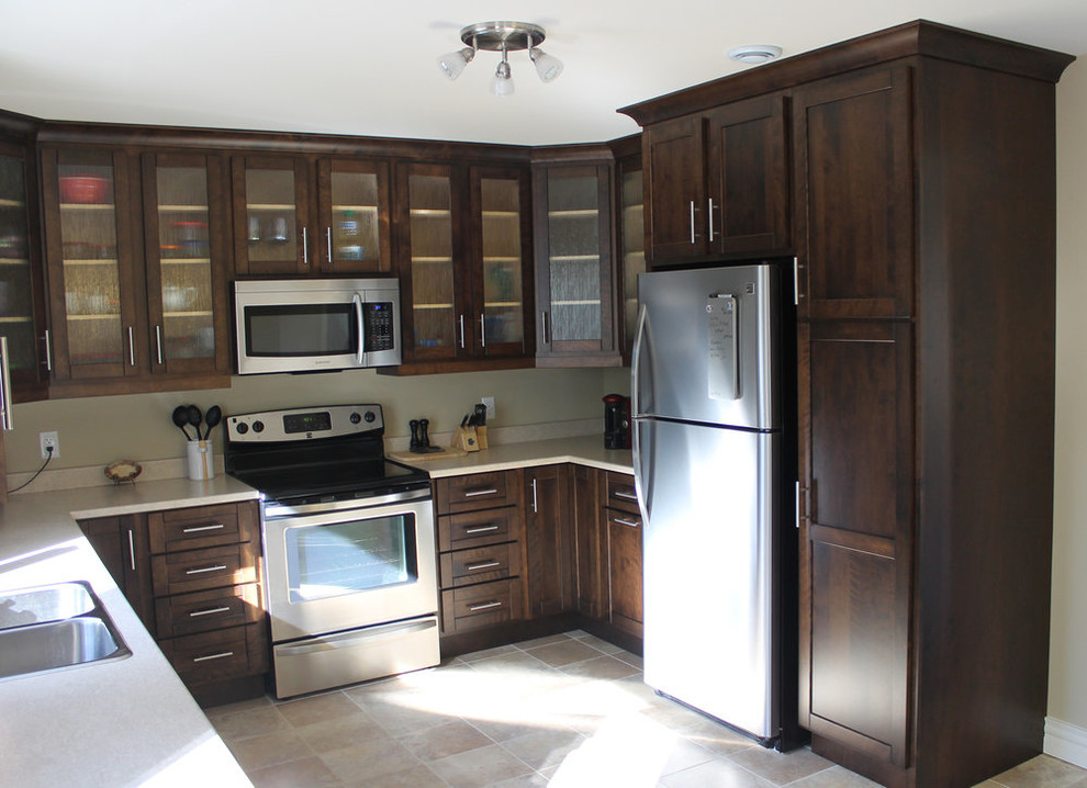 Example of a mid-sized transitional u-shaped ceramic tile and beige floor open concept kitchen design with a drop-in sink, shaker cabinets, dark wood cabinets, laminate countertops, stainless steel appliances, no island and beige countertops