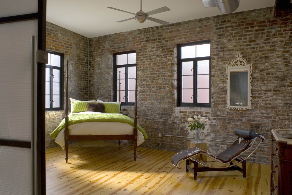 Design ideas for a mid-sized modern guest bedroom in St Louis with brown walls, medium hardwood floors and no fireplace.