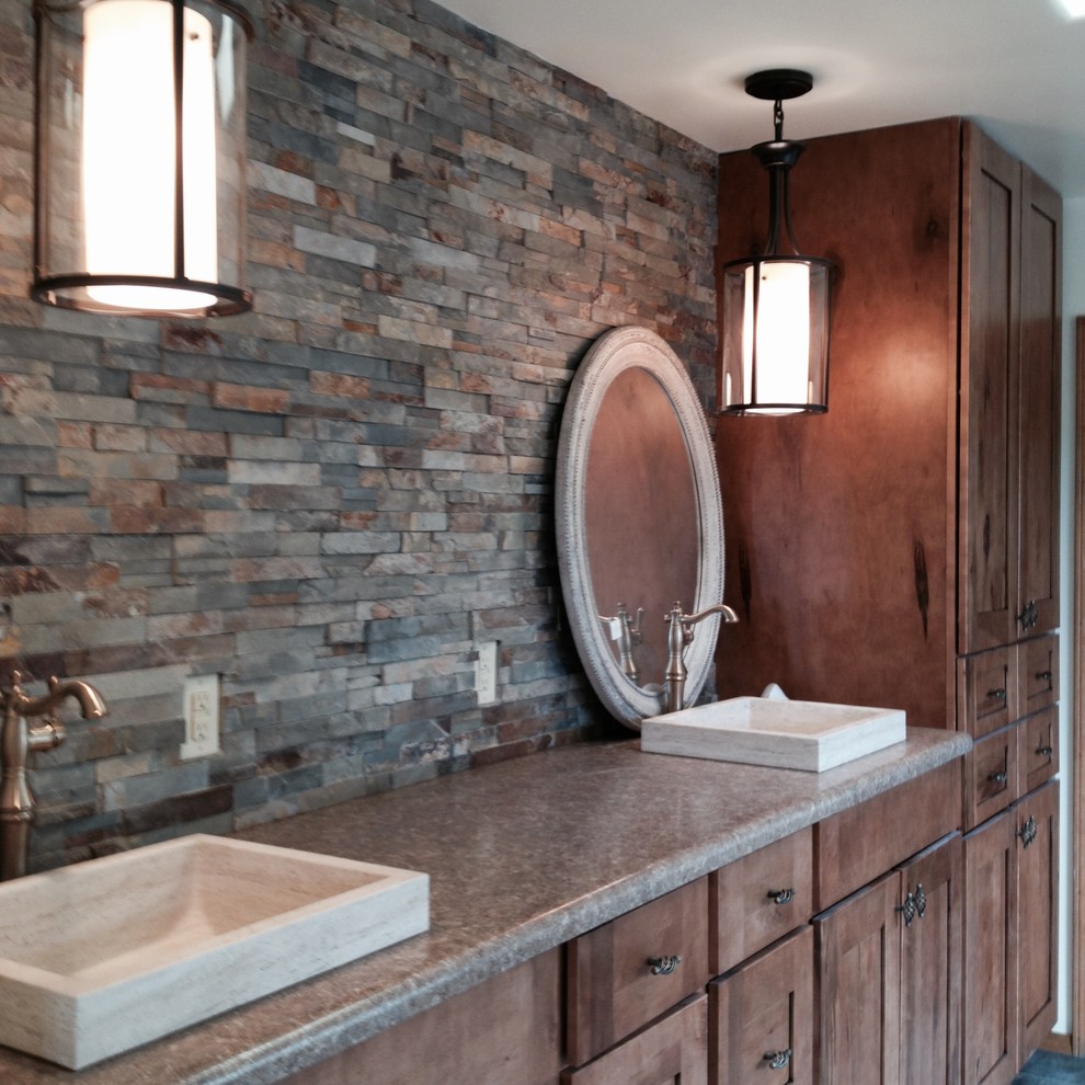 Design ideas for a large master bathroom in Houston with raised-panel cabinets, medium wood cabinets, an alcove tub, an open shower, a one-piece toilet, multi-coloured tile, stone tile, beige walls, slate floors, a drop-in sink, laminate benchtops, multi-coloured floor and an open shower.