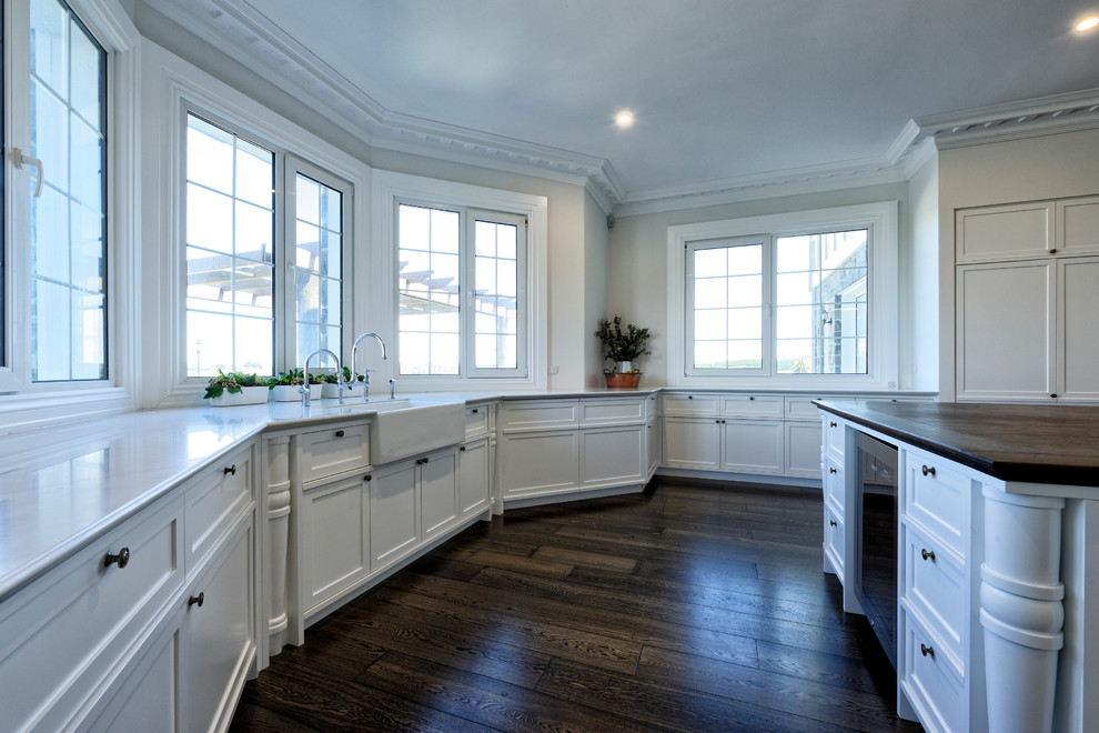 Inspiration for a large traditional u-shaped separate kitchen in Melbourne with a drop-in sink, shaker cabinets, white cabinets, wood benchtops, white splashback, subway tile splashback, stainless steel appliances and with island.