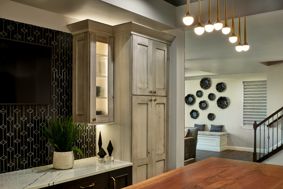 Design ideas for a large classic wet bar in Denver with a submerged sink, recessed-panel cabinets, engineered stone countertops, black splashback, porcelain splashback and vinyl flooring.