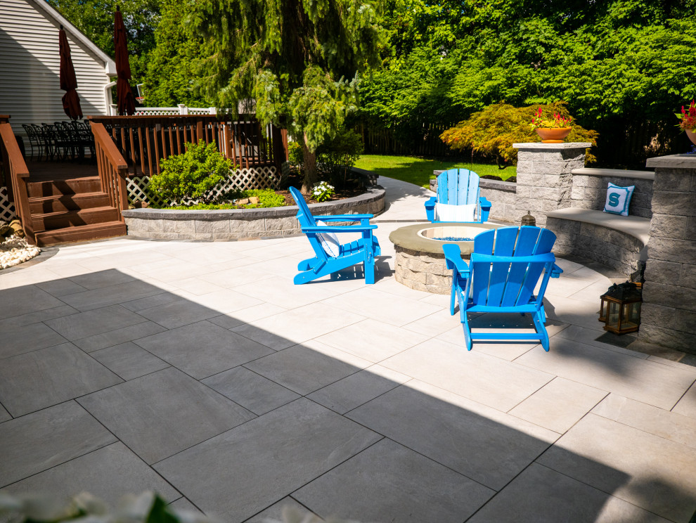 Medium sized contemporary back patio in New York with tiled flooring and a gazebo.