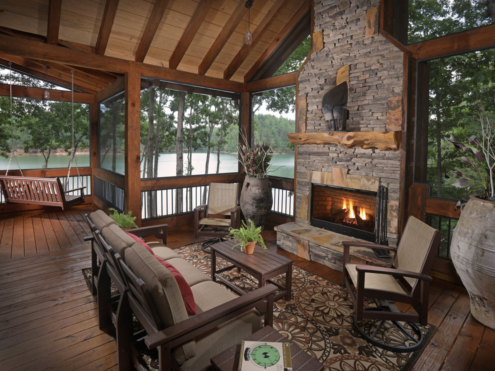 Inspiration for a country side yard deck in Atlanta with with fireplace and a roof extension.