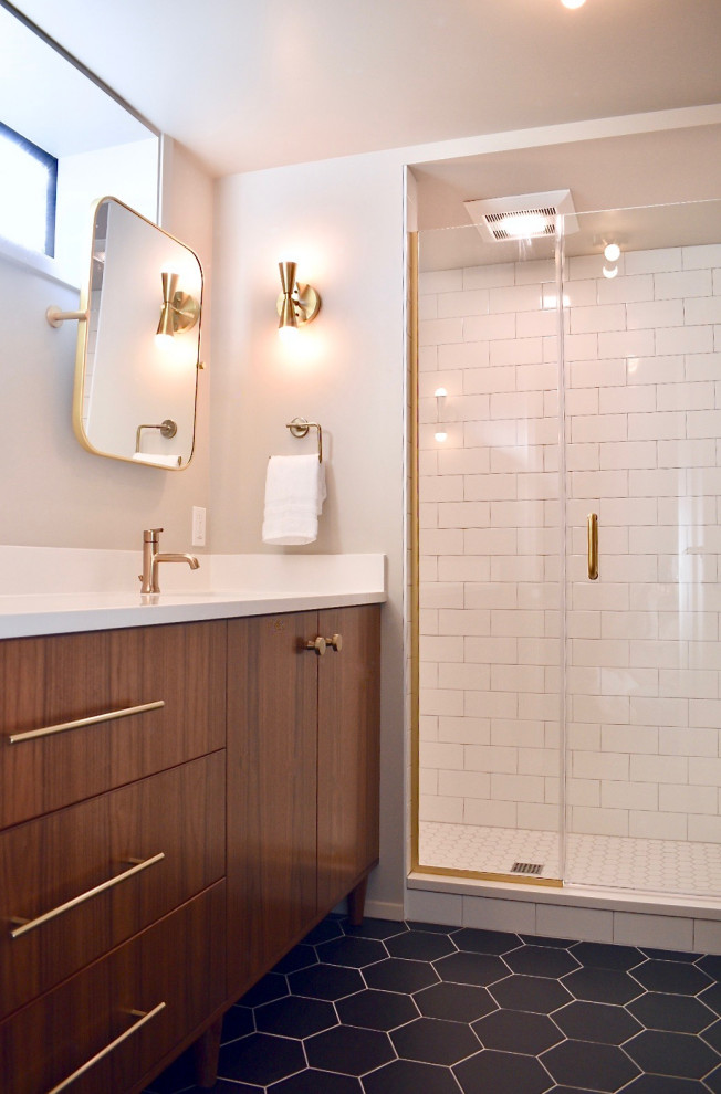 Inspiration for a mid-sized midcentury 3/4 bathroom in Seattle with dark wood cabinets, an alcove shower, a two-piece toilet, white tile, subway tile, grey walls, ceramic floors, an undermount sink, engineered quartz benchtops, black floor, a hinged shower door, white benchtops and flat-panel cabinets.