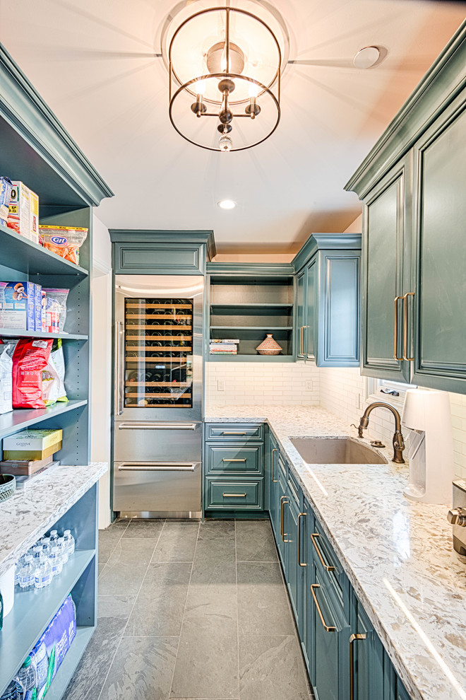 This is an example of a large transitional u-shaped kitchen pantry in Los Angeles with an undermount sink, quartzite benchtops, white splashback, subway tile splashback, stainless steel appliances, slate floors, no island, grey floor, white benchtop, raised-panel cabinets and turquoise cabinets.