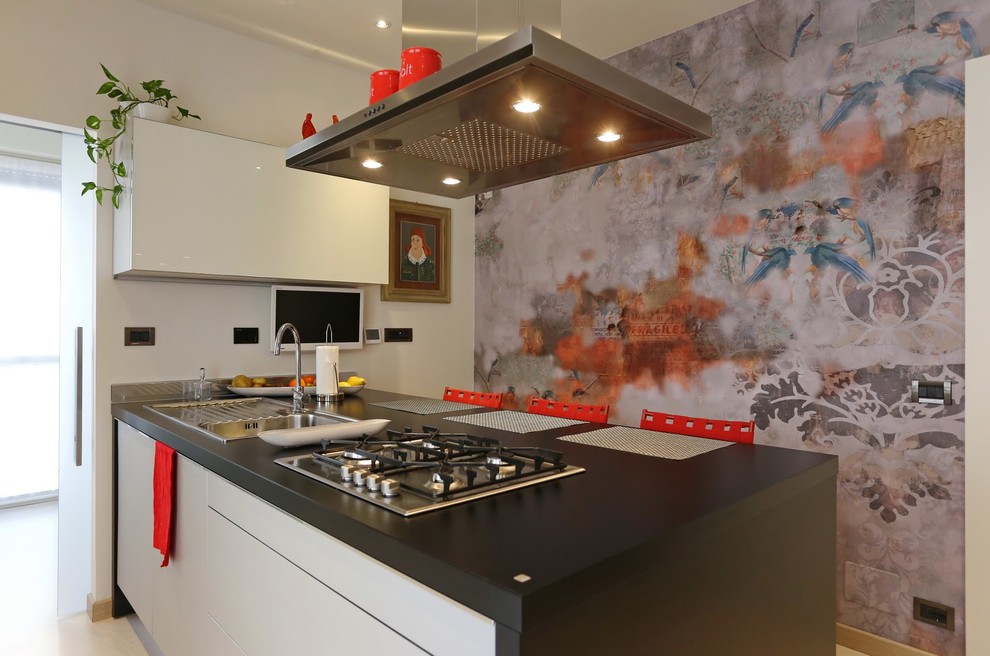 Design ideas for an eclectic galley separate kitchen in Turin with a single-bowl sink, flat-panel cabinets, black cabinets and a peninsula.
