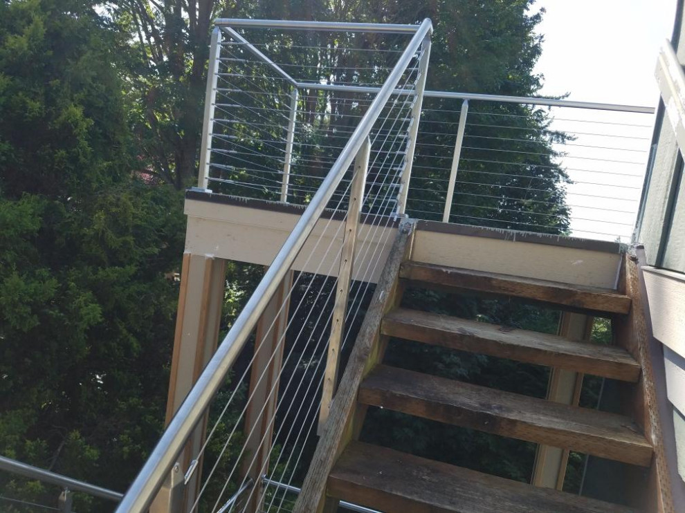 Large minimalist backyard deck photo in Seattle with no cover