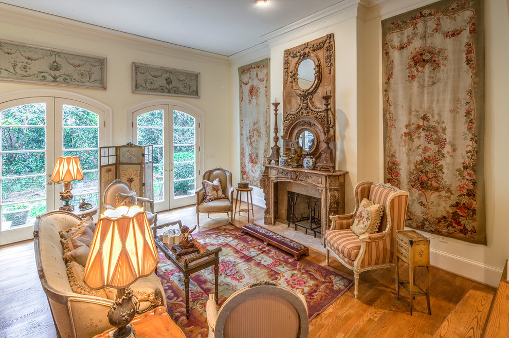 This is an example of a large traditional formal open concept living room in Atlanta with a standard fireplace, medium hardwood floors, no tv and beige walls.