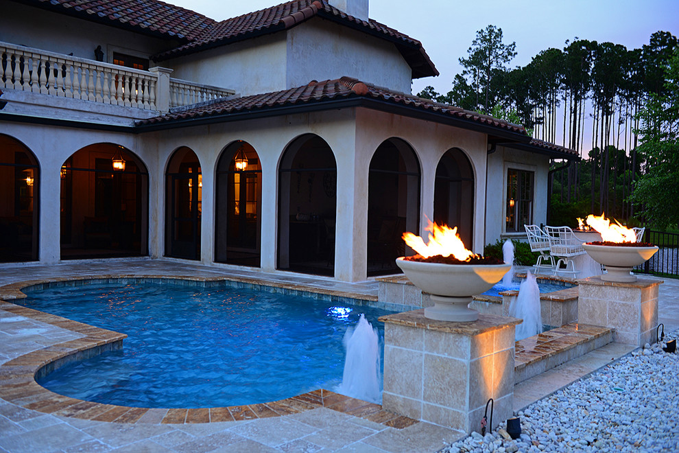 Large contemporary courtyard l-shaped natural pool in Jacksonville with a hot tub and natural stone pavers.