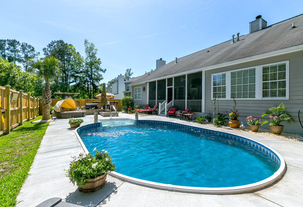 This is an example of a beach style backyard pool in Charleston with concrete slab.