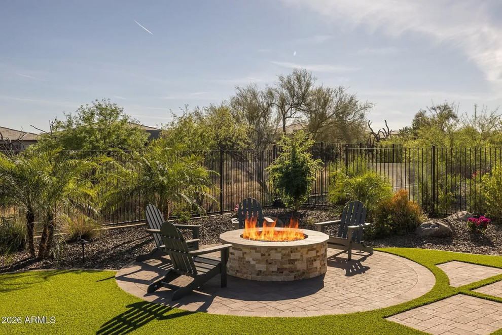 Example of a mid-sized transitional backyard concrete paver patio design in Phoenix with a fire pit