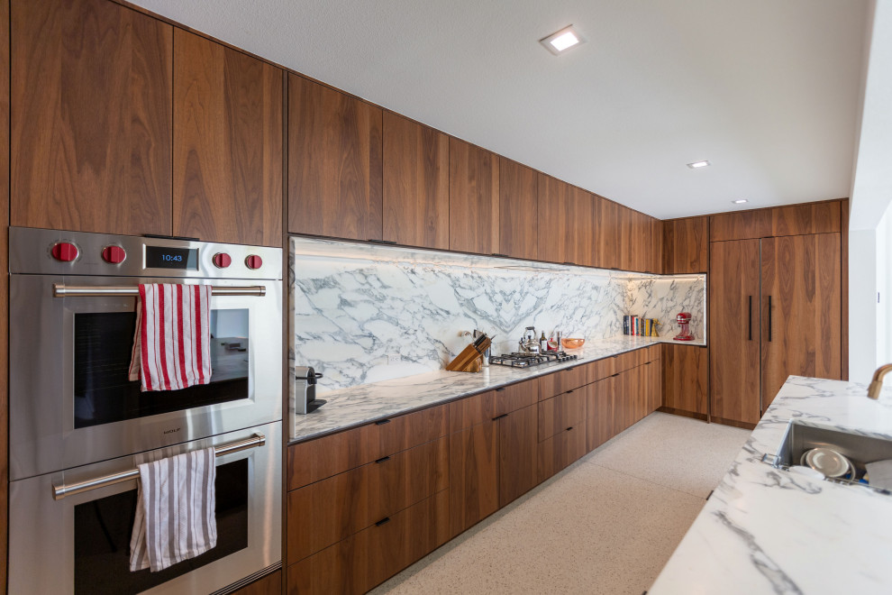 Design ideas for a large midcentury single-wall eat-in kitchen in Other with an undermount sink, flat-panel cabinets, dark wood cabinets, quartz benchtops, white splashback, engineered quartz splashback, panelled appliances, terrazzo floors, a peninsula, white floor, white benchtop and exposed beam.