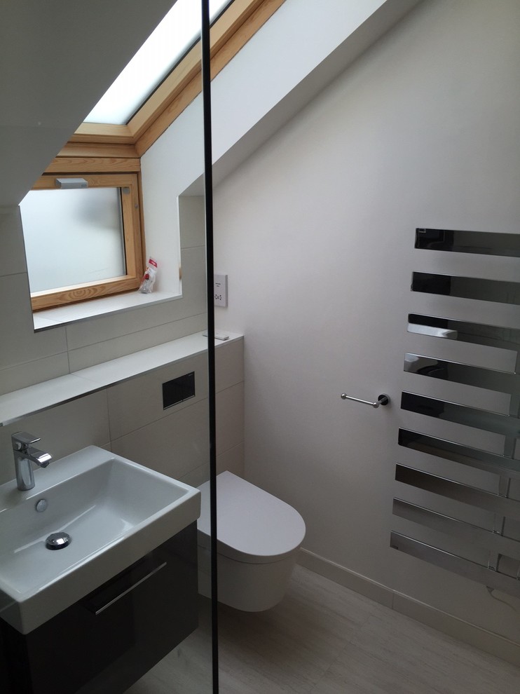 This is an example of a mid-sized contemporary master bathroom in Dorset with flat-panel cabinets, grey cabinets, an open shower, a wall-mount toilet, black and white tile, ceramic tile, white walls, porcelain floors and a wall-mount sink.