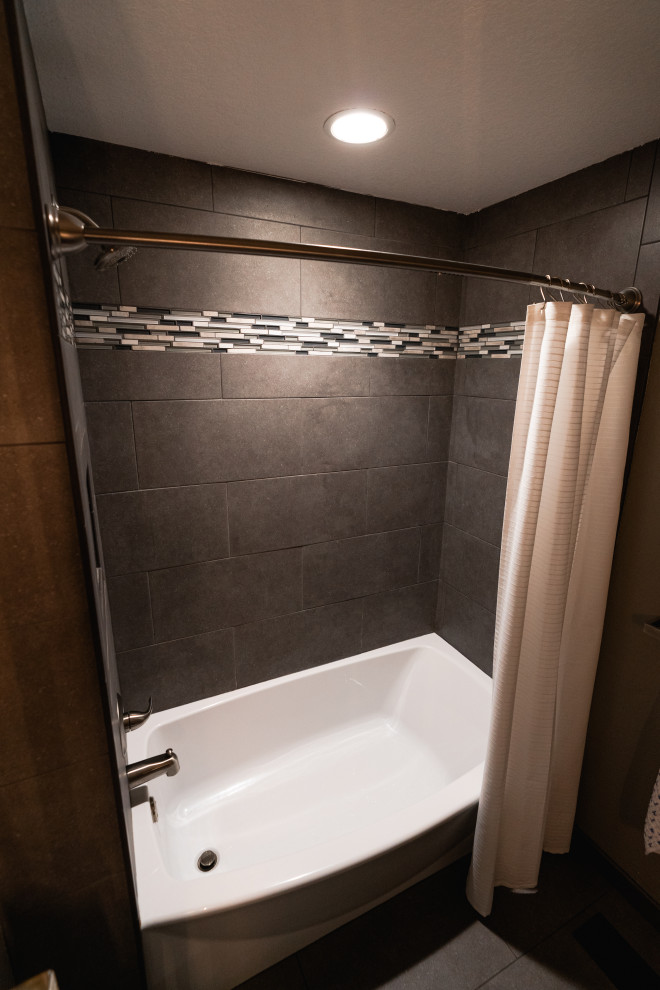 Photo of a small traditional bathroom in Seattle with shaker cabinets, dark wood cabinets, an alcove shower, porcelain tiles, engineered stone worktops, a shower curtain, a single sink and a freestanding vanity unit.