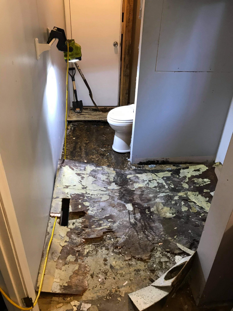Small retro ensuite wet room bathroom in Boston with shaker cabinets, white cabinets, a one-piece toilet, blue walls, ceramic flooring, laminate worktops, brown floors, a hinged door, a shower bench, a single sink, a built in vanity unit and all types of ceiling.