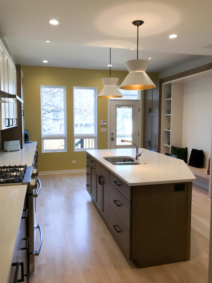 Large transitional l-shaped eat-in kitchen photo in Chicago with a double-bowl sink, shaker cabinets, white cabinets, quartz countertops, multicolored backsplash, porcelain backsplash, stainless steel appliances, an island and white countertops