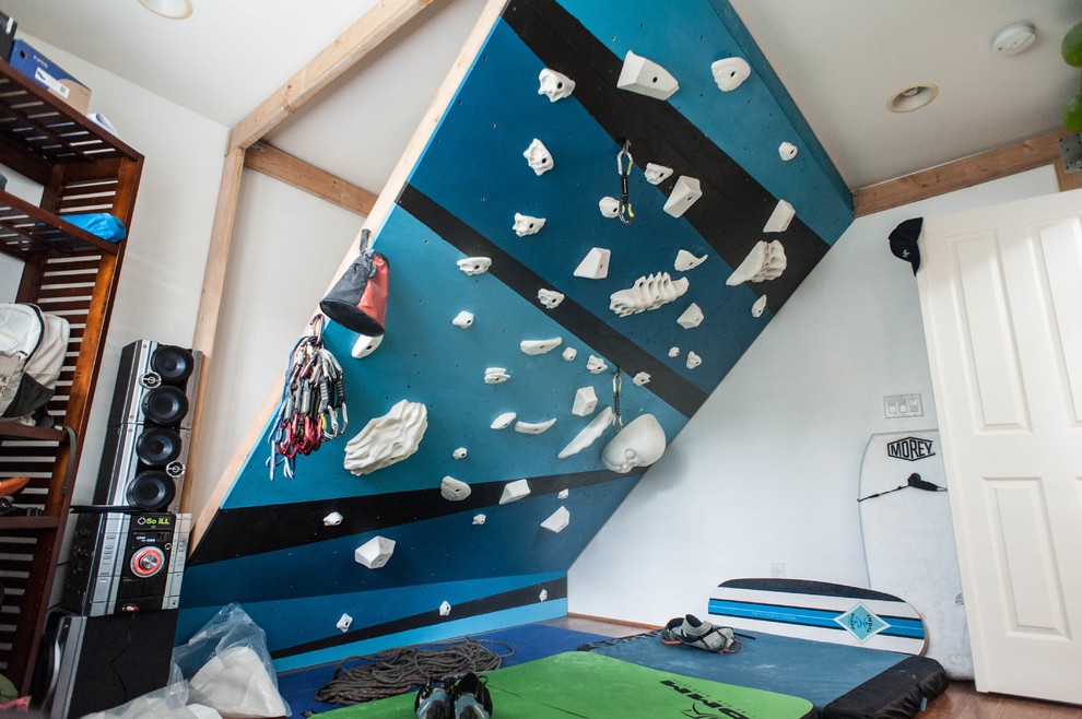 Inspiration for a small modern home climbing wall in Hawaii with white walls and bamboo floors.