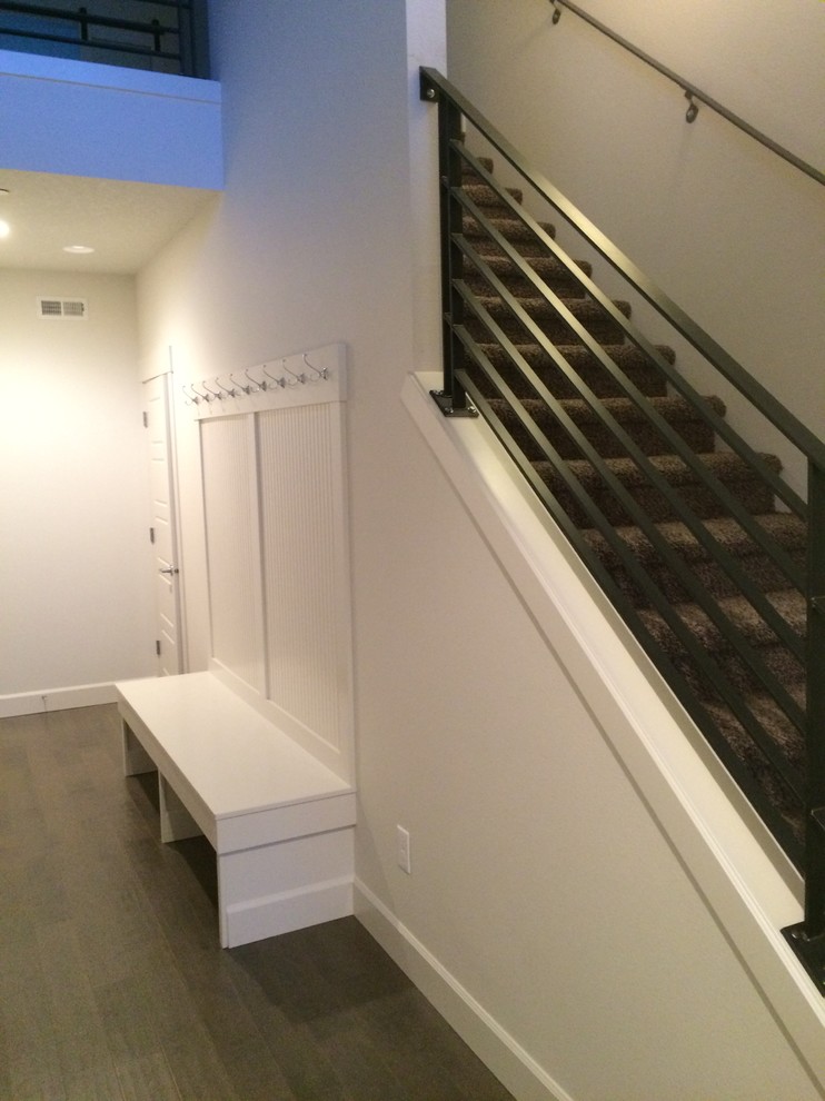 Example of a mid-sized transitional vinyl floor and gray floor mudroom design with white walls and a white front door