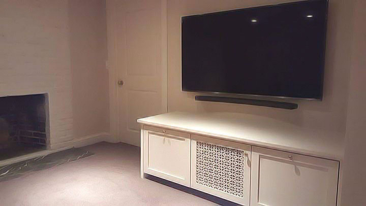 Inspiration for a mid-sized transitional underground carpeted and beige floor basement remodel with beige walls, a standard fireplace and a brick fireplace