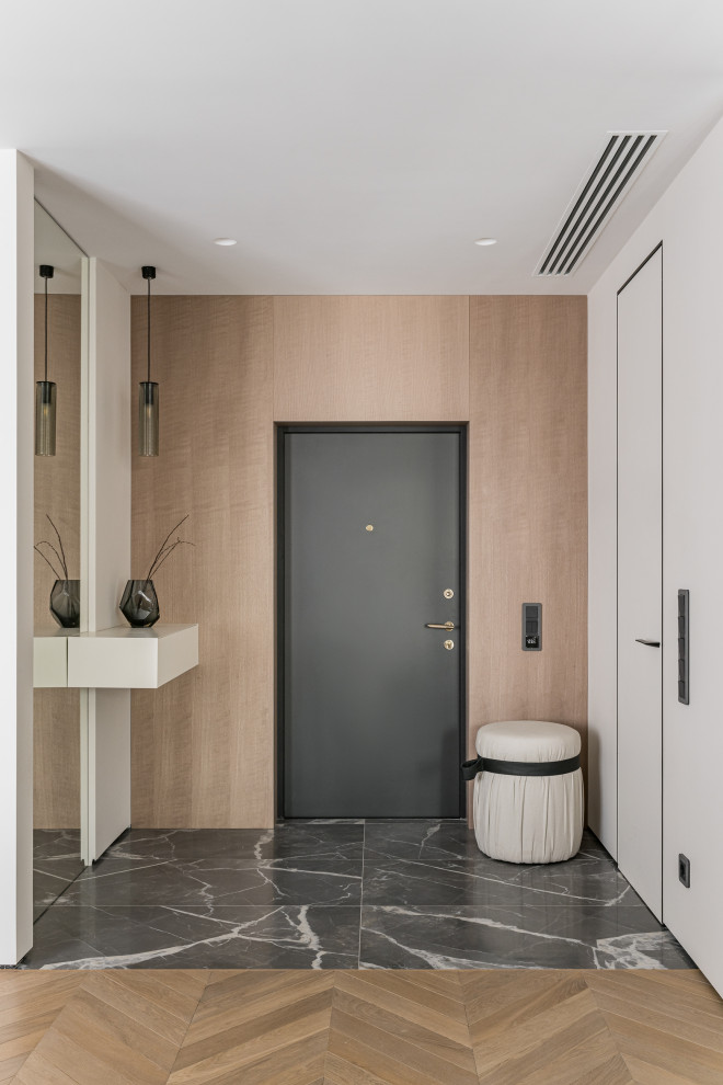 Idee per una porta d'ingresso design con pareti beige, pavimento in gres porcellanato, una porta singola, una porta grigia e pavimento grigio