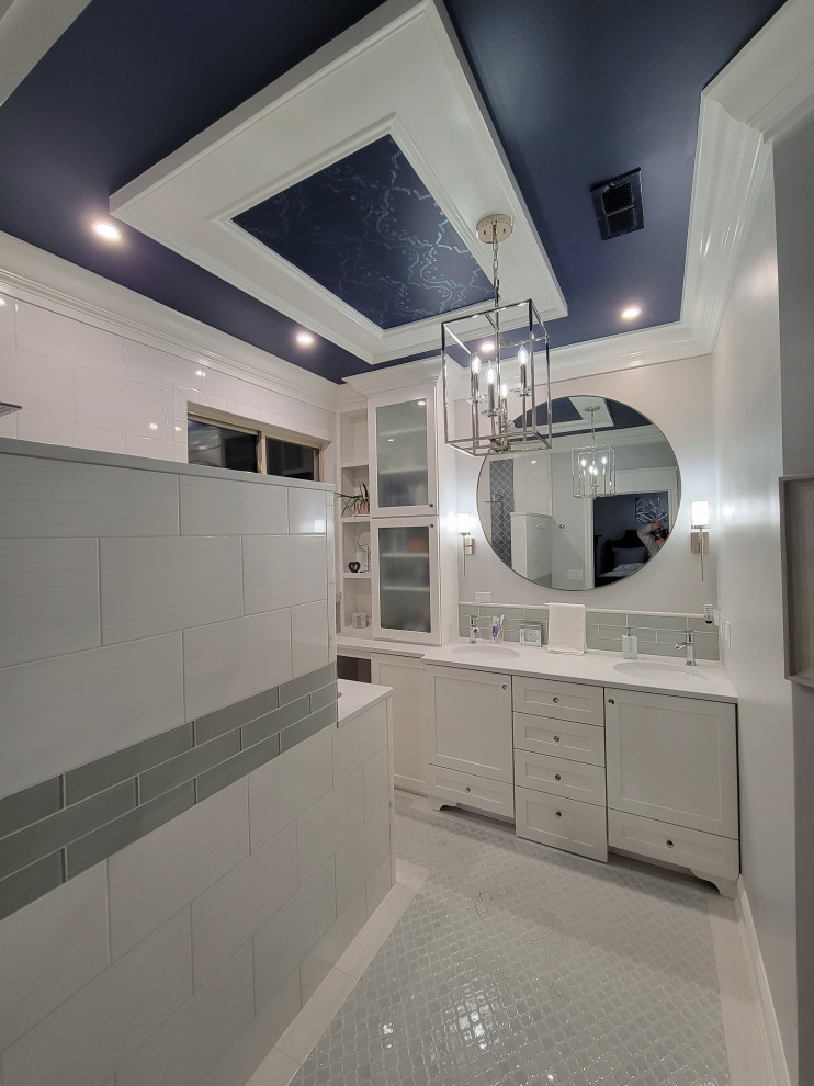 Photo of a medium sized traditional ensuite bathroom in Cincinnati with shaker cabinets, white cabinets, a built-in shower, a two-piece toilet, white tiles, ceramic tiles, grey walls, porcelain flooring, a submerged sink, quartz worktops, grey floors, an open shower, grey worktops, a wall niche, double sinks, a built in vanity unit and a drop ceiling.