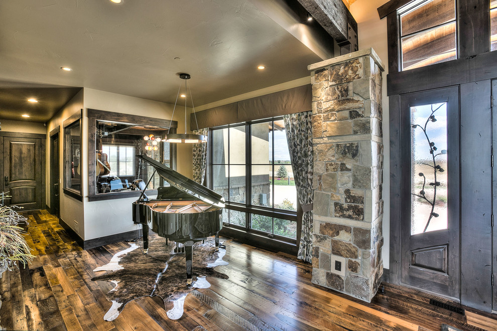 Huge mountain style medium tone wood floor front door photo in Denver with beige walls and a dark wood front door