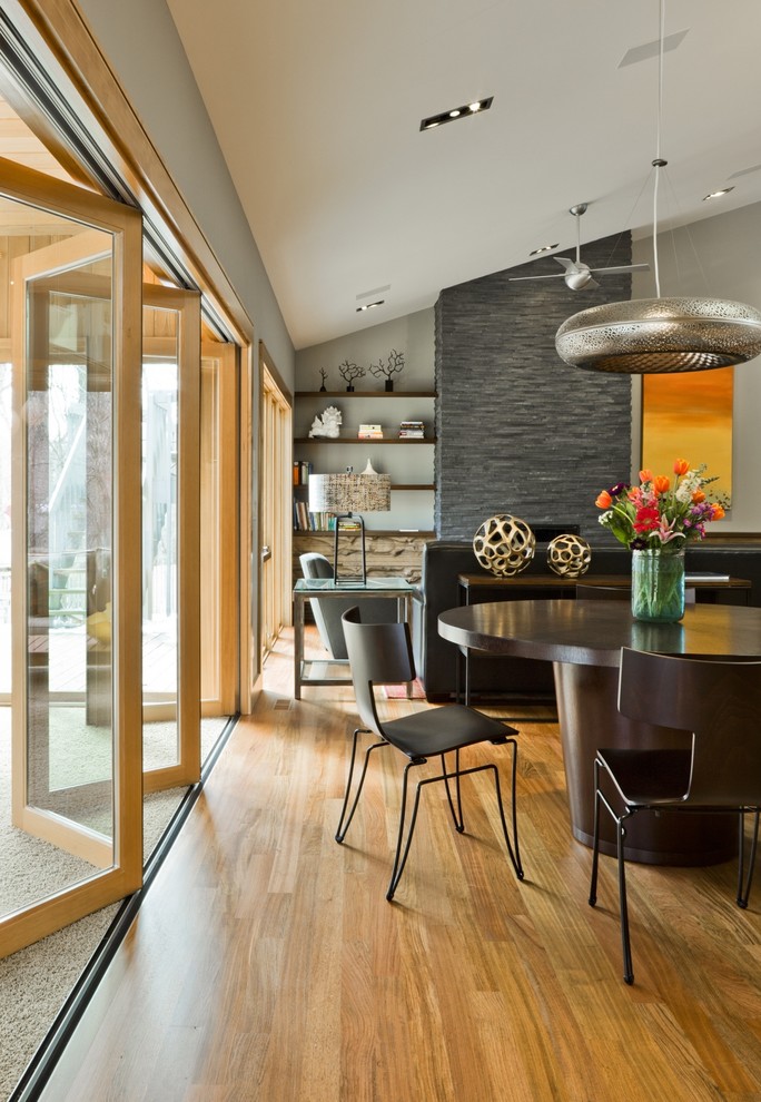 Contemporary open plan dining in New York with grey walls and medium hardwood floors.