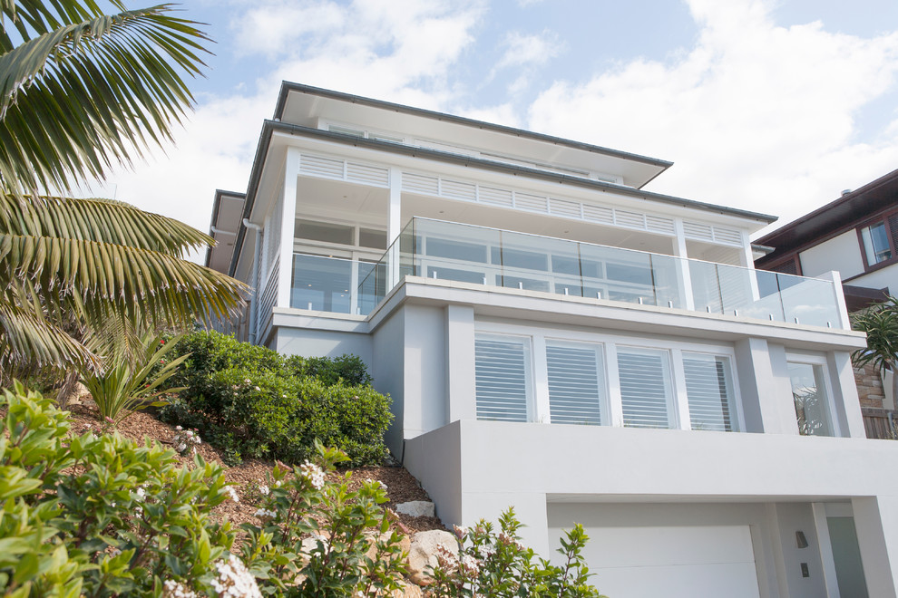 Design ideas for a large beach style three-storey concrete grey exterior in Sydney with a hip roof.
