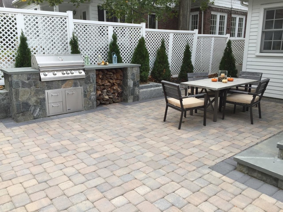 Inspiration for a mid-sized transitional backyard concrete paver patio remodel in Orange County with a fire pit and no cover