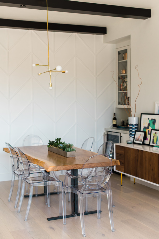 Photo of a small transitional open plan dining in San Francisco with white walls and light hardwood floors.