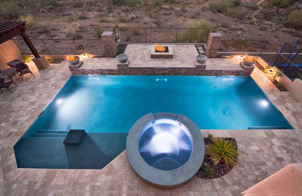 Inspiration for a large modern backyard stone and custom-shaped pool fountain remodel in Phoenix