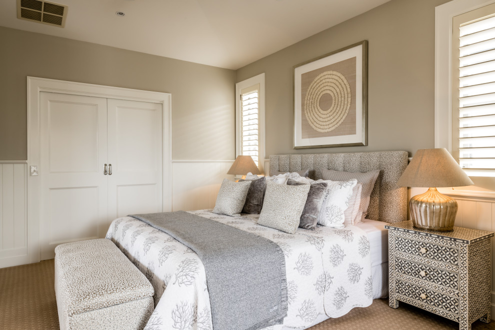 Mid-sized beach style master bedroom in Geelong with grey walls, carpet and brown floor.
