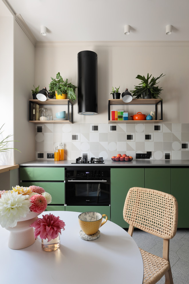 Inspiration for a small scandinavian l-shaped eat-in kitchen in Saint Petersburg with a drop-in sink, flat-panel cabinets, green cabinets, solid surface benchtops, grey splashback, ceramic splashback, black appliances, ceramic floors, grey floor and grey benchtop.