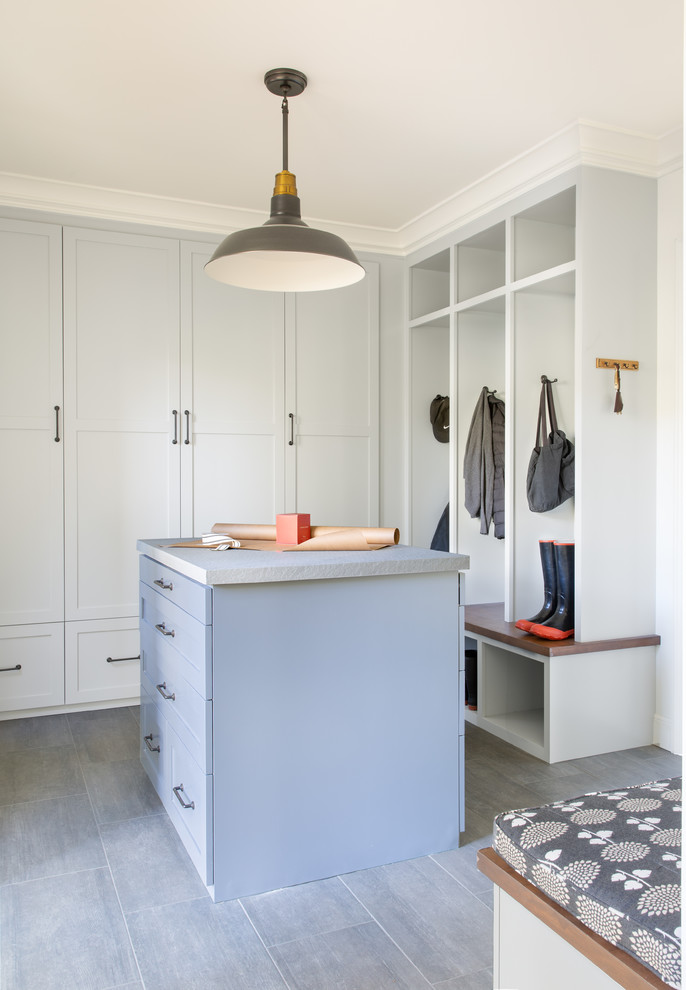 Photo of a beach style mudroom in San Francisco with grey floor.