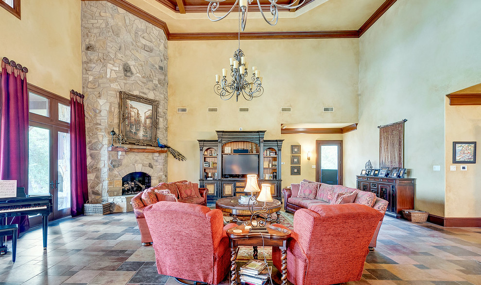 Expansive mediterranean formal open concept living room in Dallas with beige walls, ceramic floors, a corner fireplace, a stone fireplace surround, a built-in media wall and multi-coloured floor.