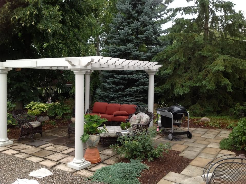 This is an example of a large transitional backyard stone landscaping in Ottawa.