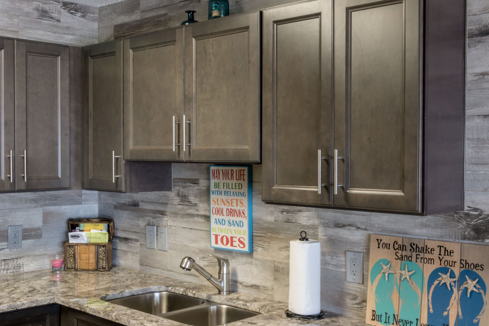 Example of a small mountain style u-shaped cement tile floor and beige floor eat-in kitchen design with an undermount sink, flat-panel cabinets, medium tone wood cabinets, granite countertops, gray backsplash, ceramic backsplash, stainless steel appliances, a peninsula and gray countertops