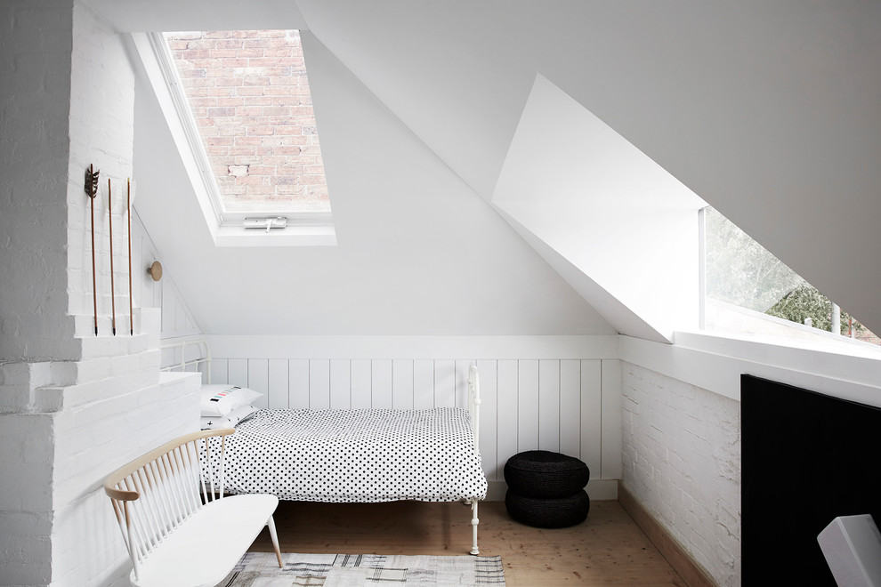 This is an example of a scandinavian gender-neutral kids' bedroom for kids 4-10 years old in Melbourne with white walls, light hardwood floors and beige floor.