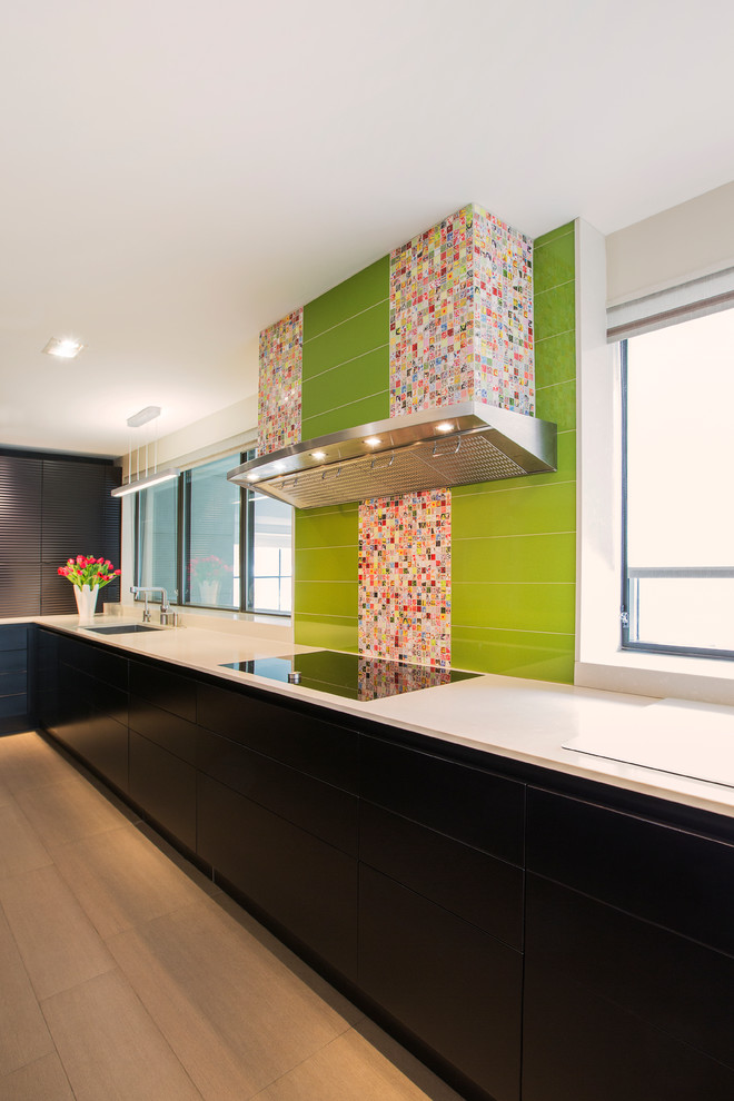 Photo of a contemporary single-wall kitchen in Toronto with flat-panel cabinets, black cabinets, multi-coloured splashback, stainless steel appliances and with island.